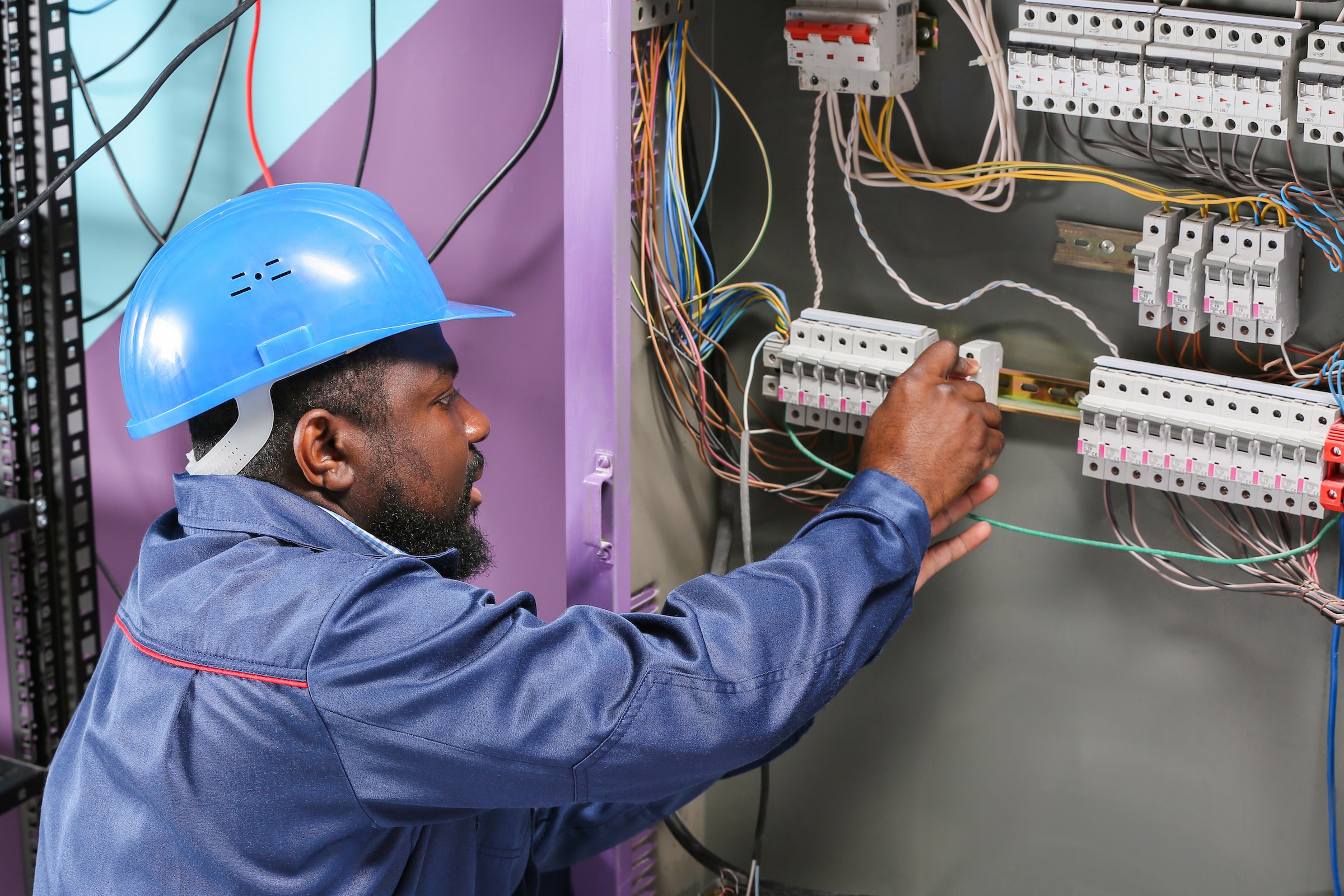 Man working on electrical fuses